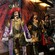 Marionettes representing a queen, a king and 2 warriors stand against a theater backdrop